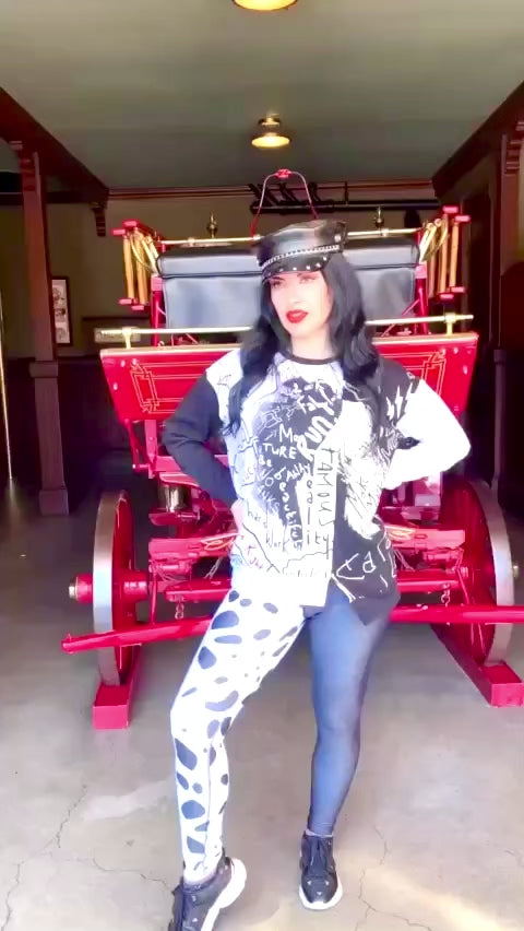 Our model wears a fun Cruella inspired ensemble with dalmation print leggings inside the original firehouse in Disneyland.